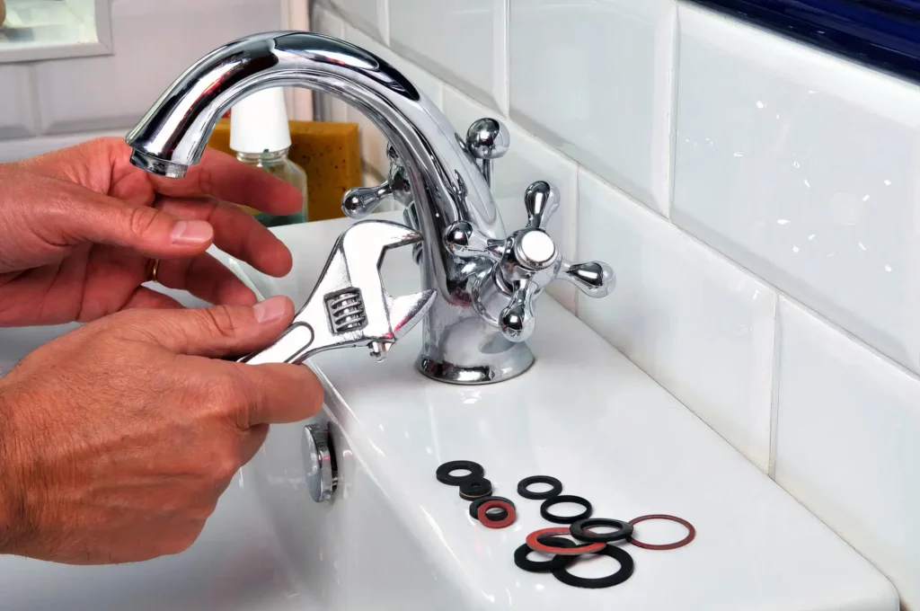 Plumber performing maintenance on a bathroom faucet in Miami Gardens
