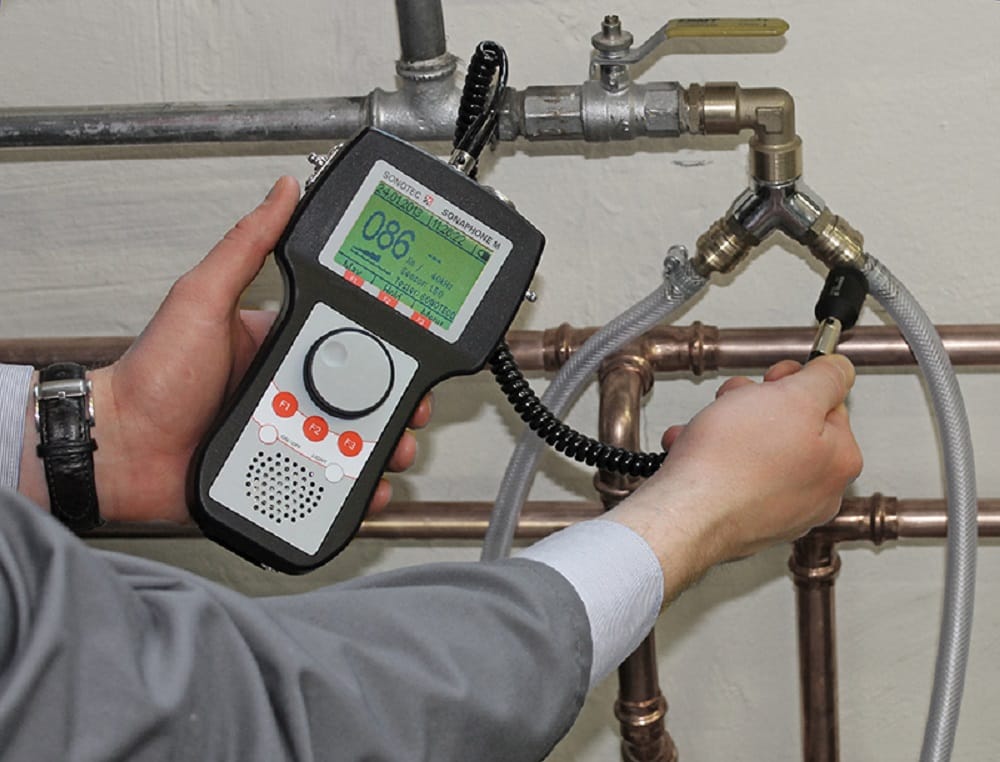 Plumber testing pipes with electronic leak detection equipment in Miami Gardens