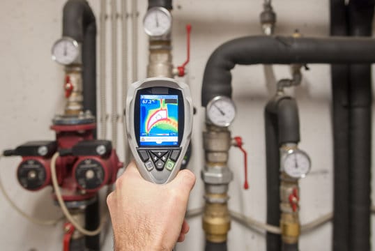 Plumber using a thermal imaging camera to inspect pipes in Miami Gardens