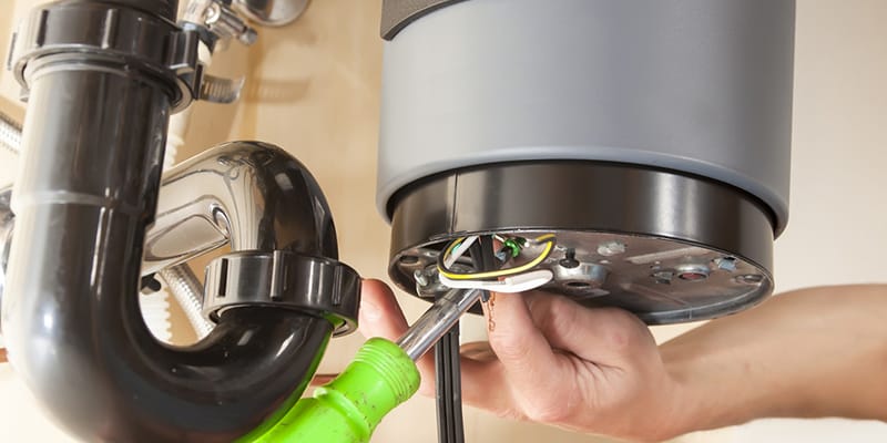 Technician repairing the heating element of a water heater in Miami Gardens