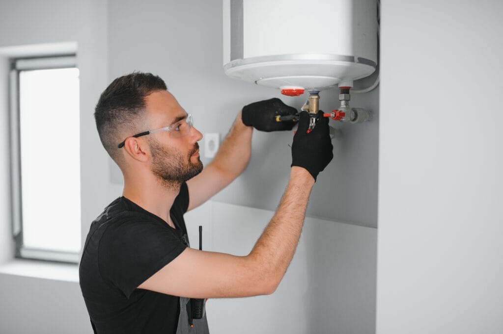 Technician performing water heater maintenance in Miami Gardens