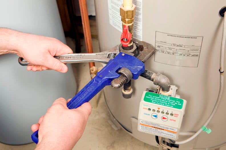Plumber repairing a water heater valve in Miami Gardens